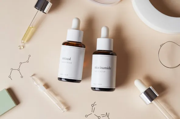Retinol and Niacinamide serum bottles with molecular structure diagrams